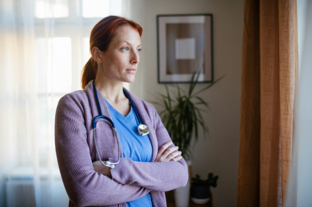 Portrait of young nurse, concept of healthcare in seniors home.