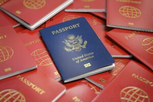 Passport of USA on the pile of passports of other countries. Immigration concept.