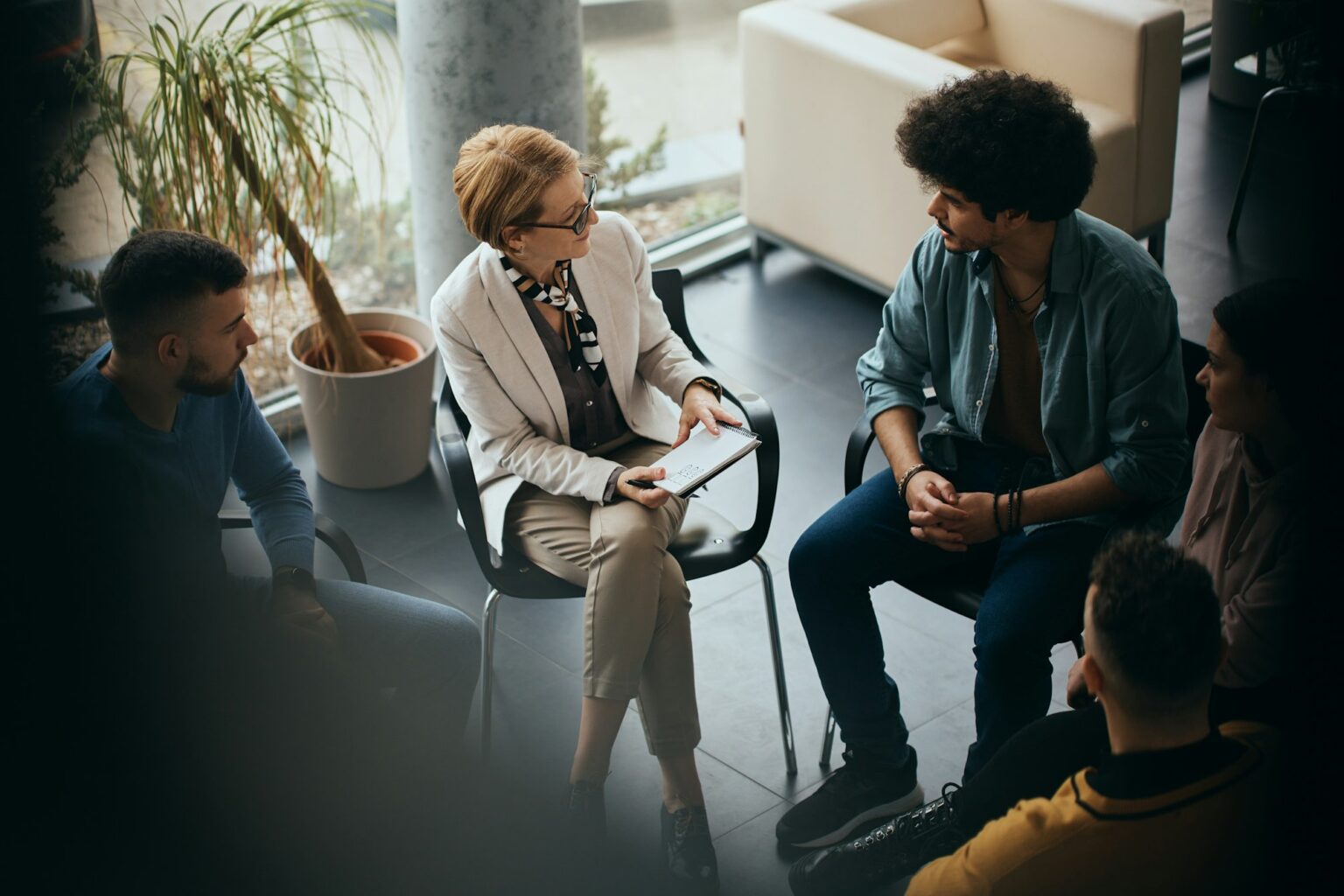 Above view of counseling during group therapy at mental health center.