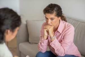 Woman Listening to Therapist in Counseling Session