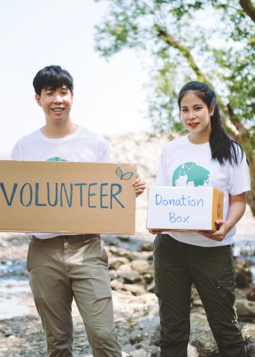 Group of volunteers hold a volunteer sign in world environment day event, volunteer conservation.